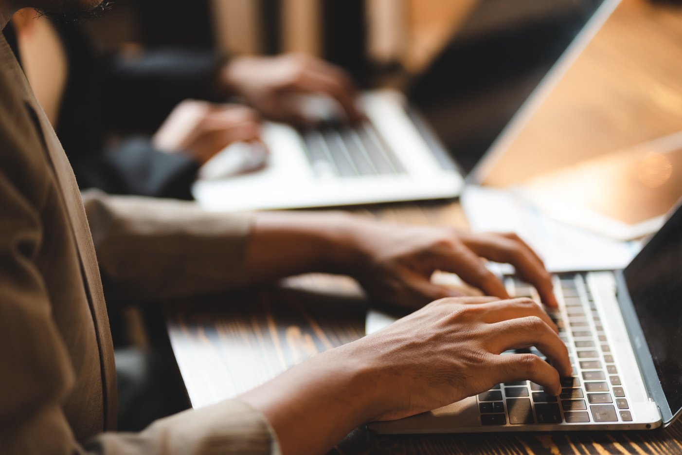 professional business person typing on computer laptop desk